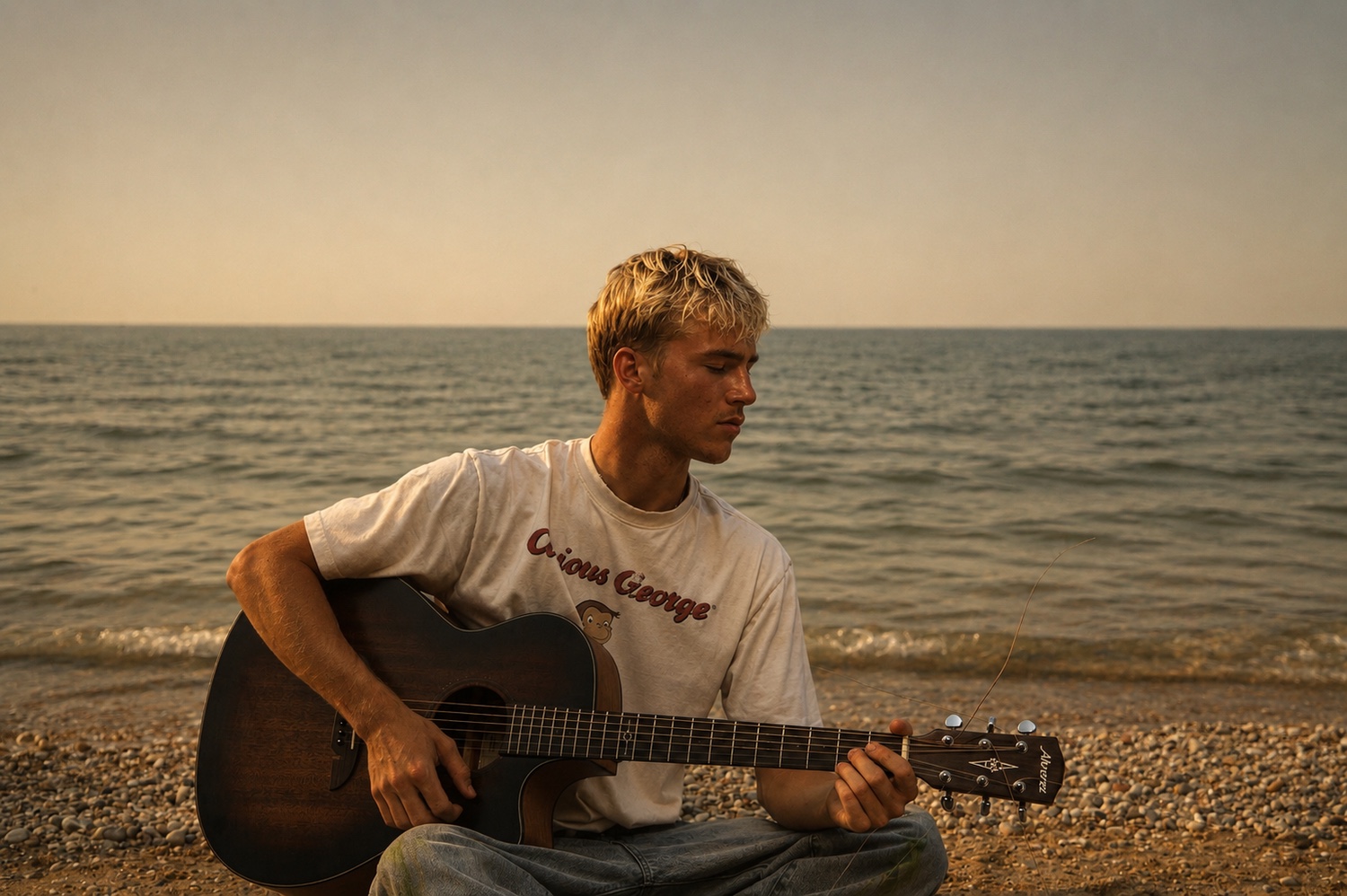 A musician with an acoustic guitar beside the water.